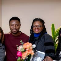 Group of 4 hold flowers and smile for picture